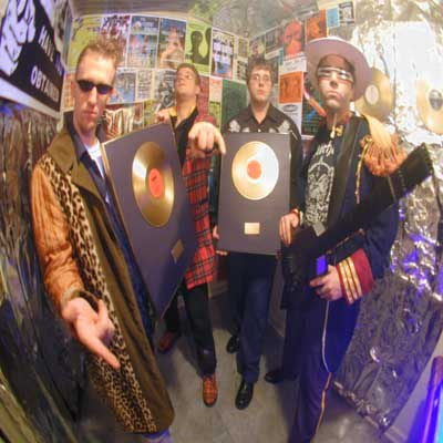 Spindrift posing with framed records